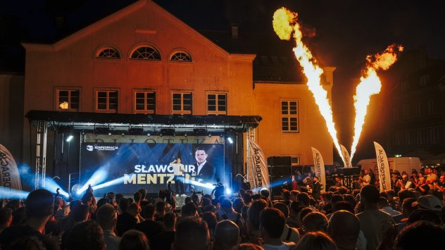 Съпредседателят на Конфедеративния алианс Славомир Менцен пие бира, докато говори по време на митинг в Олщин, Полша, на 26 август. Снимка: Дамян Лемански/Bloomberg