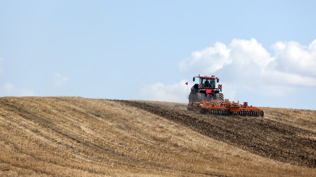 Трактор тегли машина за обработка на почвата.Снимка: Крис Ратклиф/Bloomberg