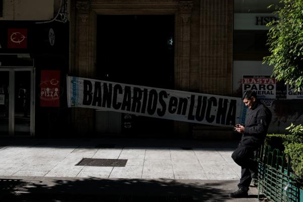 <p>Минувач пред плакат на входа на HSBC в Буенос Айрес, призоваващ за стачка. 25 юни 2018. Photographer: Erica Canepa/Bloomberg.</p>
